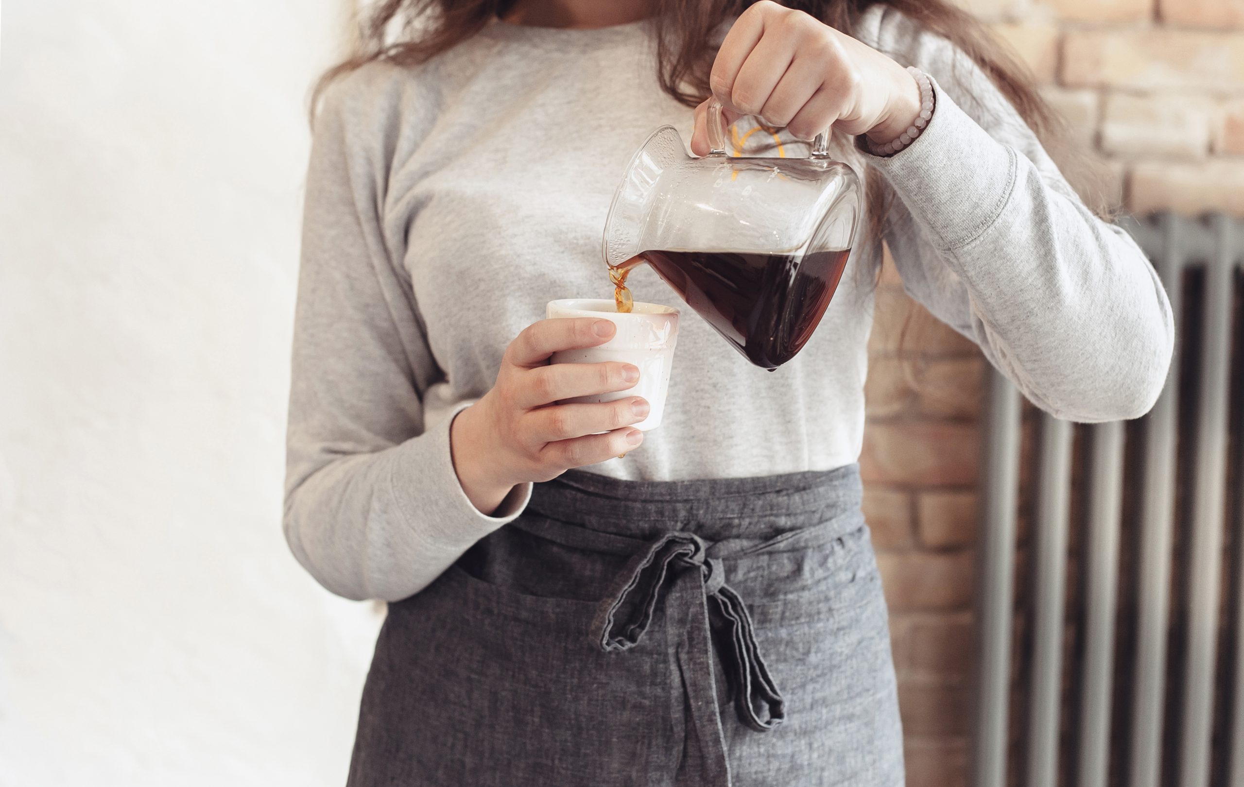 Lady pouring cup of coffee