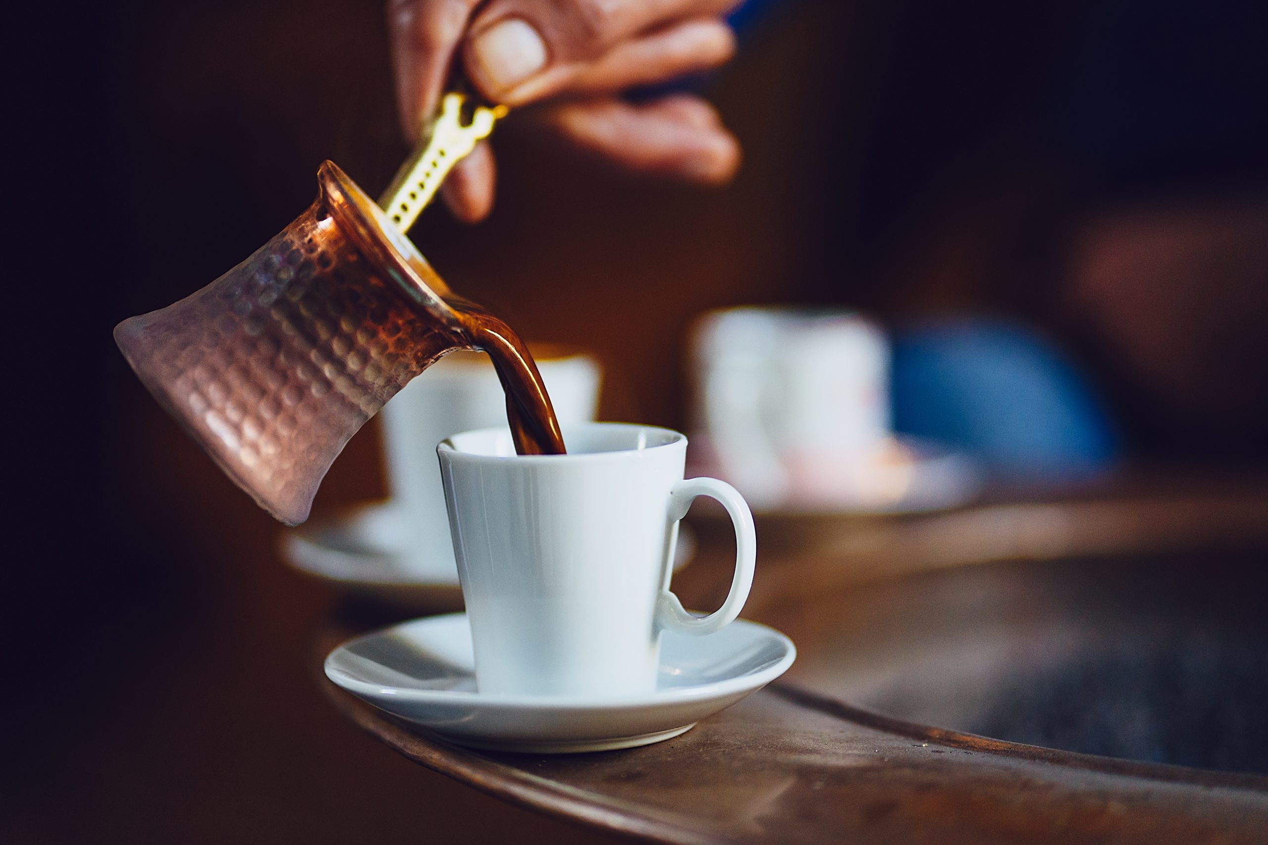 Pouring Turkish coffee into a cup