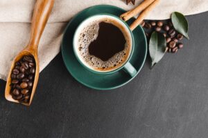 Cup of coffee with coffee beans on the table