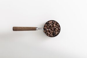 Coffee beans in measuring cup